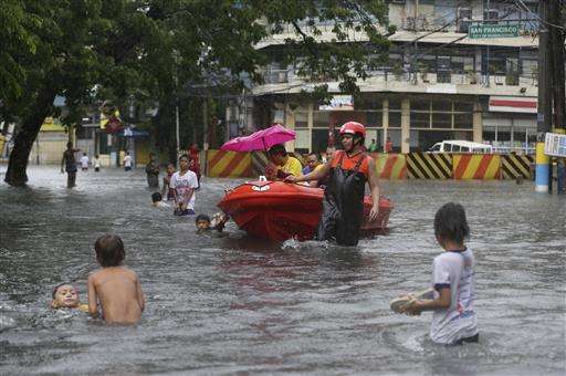 Typhoon drenches Taiwan, kills 2 people; floods hit Manila