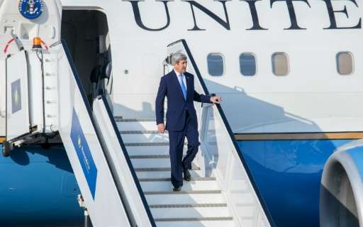 US Secretary of State John Kerry disembarks from his plane at Kigali International Airport on October 13, 2016