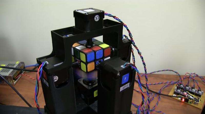 Record-seeking pair show off robot solving Rubik’s Cube