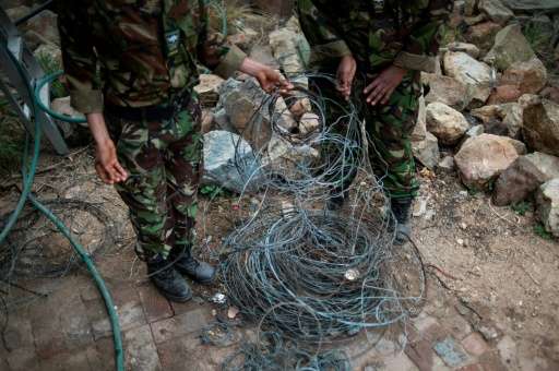 Members of the anti-poaching team &quot;Black Mambas&quot; collect wire traps from a wildlife reserve in Hoedspruit, in the Limp