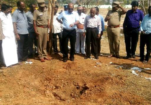Scientists inspect the crash site of a suspected meteorite that landed in the Vellore district of Tamil Nadu state, southern Ind