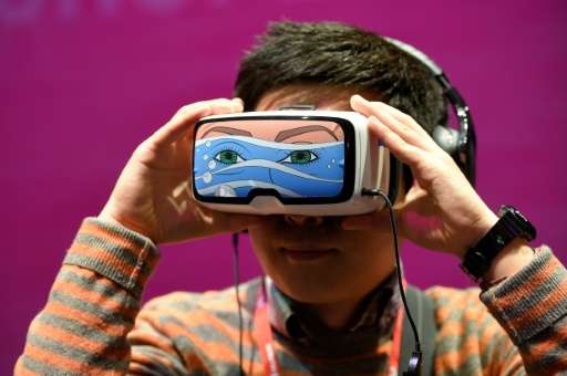 A boy tests the 'Oculus VR' virtual device, at the Deutsche Telekom stand