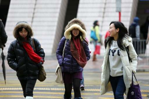 A cold snap gripped Hong Kong on January 24, with residents shivering as temperatures plunged to the lowest point in nearly 60 y