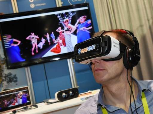 A delegate uses a virtual reality headset during a visit to the YouVisit booth at the Consumer Electronics Show in Las Vegas, on
