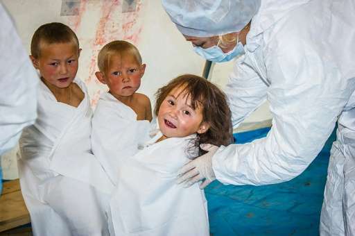 A doctor takes a health checkup of children outside Yar-Sale town at Yamal Peninsula following a recent anthrax outbreak in the 
