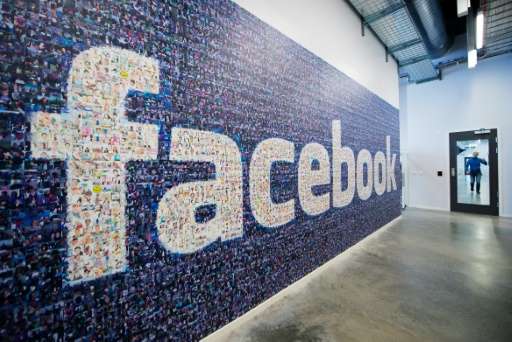 A giant logo created with pictures of Facebook worldwide users is pictured in the company's Data Center, its first outside the U