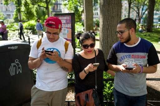A group of friends play Pokemon Go on their smartphones at Union Square in New York, on July 11, 2016