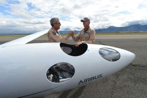 Airbus Group CEO Tom Enders (R) shakes hands with chief pilot Jim Payne after the two landed a test flight of the Airbus Perlan 