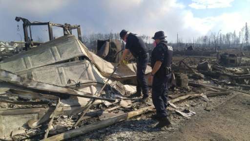 Alberta Royal Canadian Mounted Police inspect burnt out homes destroyed by the Fort McMurray Wildfire, on May 7, 2016