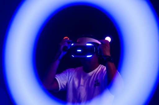 A man plays a Sony Playstation virtual reality game at the annual Ani-Com show in Hong Kong on July 29, 2016