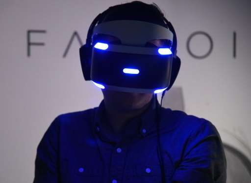 A man tries the new Sony VR headset at the E3 video game gathering in Los Angeles, California on June 13, 2016