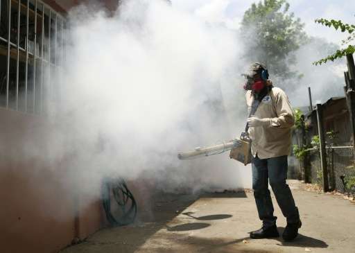 A Miami-Dade County mosquito control inspector sprays pesticide to kill mosquitos in the Wynwood neighborhood on August 2, 2016