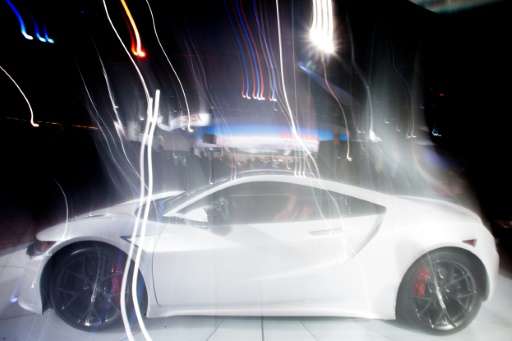 An Acura NSX is photographed with a long exposure as it rotates on a turntable at the 2016 North American International Auto Sho