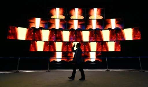 An attendee walks by a video display at the Samsung booth at CES 2016 on January 6, 2016 in Las Vegas, Nevada