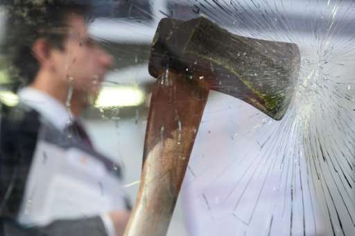 An axe and the effect it has on ballistic glass is displayed at the Security and Counter Terror Expo in London on April 19, 2016