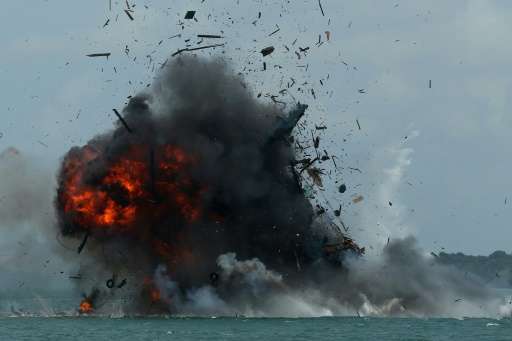An impounded fishing boat is blown up in Batam, Kepulauan Riau province on February 22, 2016
