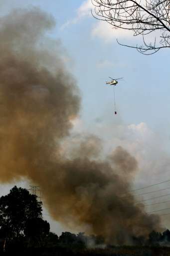 An Mi-17 helicopter from Indonesia's National Disaster Mitigation Agency conducting water-bombing operations to put out forest f