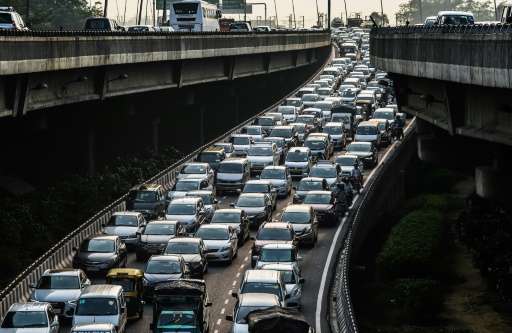 A picture taken on October 15, 2015, shows a stream of cars backed up on an exit to a highway in New Delhi but Delhi city govern
