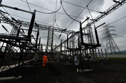 A plant technician inspects the distribution lines at the Wayang Windu geothermal power station on West Java