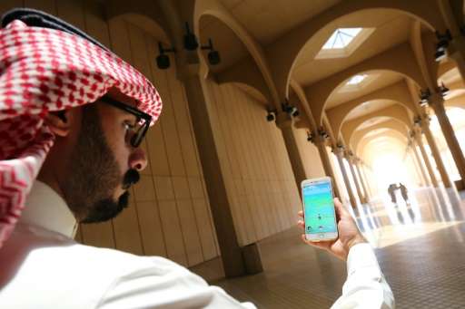 A Saudi man plays with the Pokemon Go application on his mobile in Riyadh on July 17, 2016