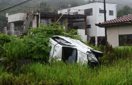 A vehicle and houses damaged by the 2011 tsunami lie untouched after four years, in the village of Tomioka, in Fukushima prefect