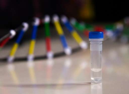 A vial containing a few droplets of water—and one million copies of an old movie encoded onto DNA—is displayed during a media to