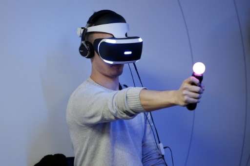 A visitor plays a game on a Playstation VR on October 28, 2015 at Paris Game Week, a trade fair for video games in Paris