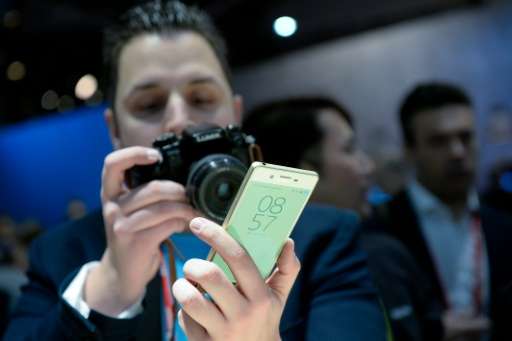 A visitor takes photos of the new Sony smartphone &quot;Sony Xperia XA&quot; at the Mobile World Congress