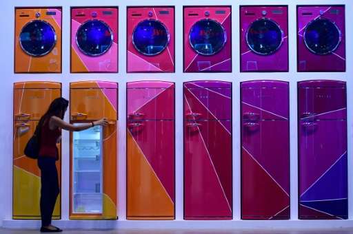 A woman looks at a fridge installation at the Vestel booth at the IFA electronics trade fair in Berlin