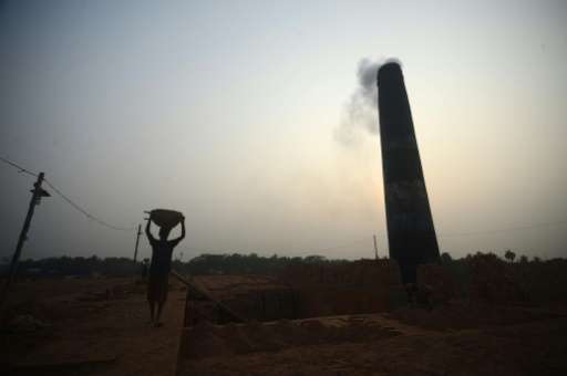 Bangladeshi labourers work at a brick factory on the outskirts of Khulna on January 19, 2016