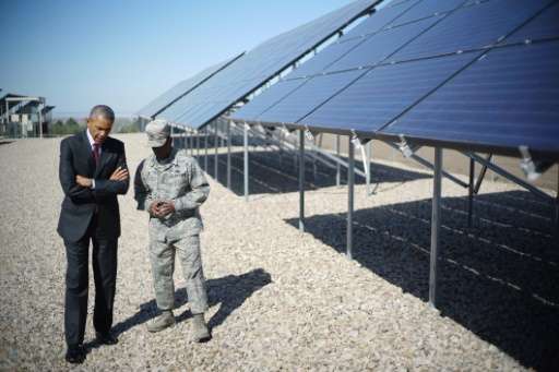 Barack Obama speaks with Commander Col Ronald Jolly as he visits a solar array at Hill Air Force Base in Utah on April 3, 2014
