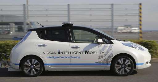 Cars without drivers scoot around Nissan plant, towing cars