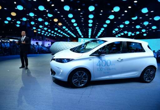 CEO French carmaker Renault, Carlos Ghosn, talks in front of an electric car on the first press day of the Paris motor Show, on 