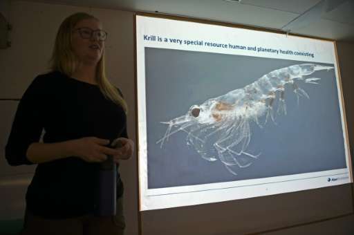 Cilia Indahl, head of sustainability at Norwegian fishing company Aker BioMarine, speaking next to a picture of a krill aboard t