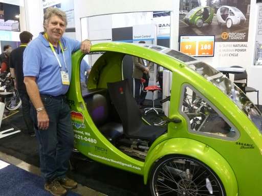Craig Sparks of Organic Transport shows the Elf solar- and pedal-powered vehicle touted as the world's most environmentally frie