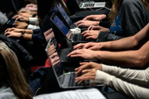 Due to a lack of certain symbols and accents, typing on some French keyboards, as these students at the Catholic University in L