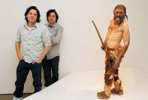 Dutch artist Adrie Kennis (L) and Alfons Kennis, the two artists who made the reconstruction of a mummy of an iceman named Otzi,