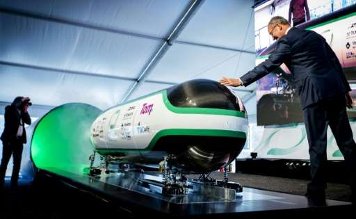 Dutch Minister for economic affairs Henk Kamp checks out the prototype during the unveiling of the Hyper Loop capsule from the D