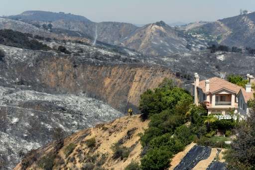 Hills burnt from a wildfire surrounding a home on Ganelon Drive on June 5, 2016 in Calabasas, California, where some 5,000 peopl