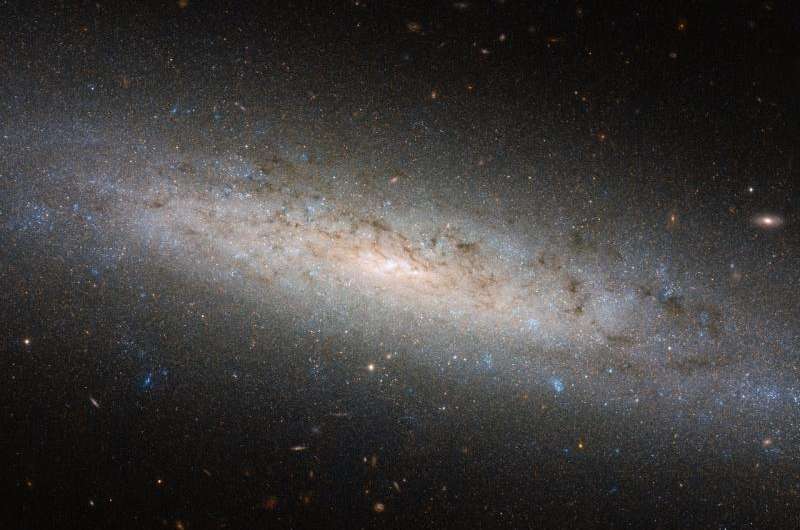 Image: Hubble explores the hidden dark side of NGC 24