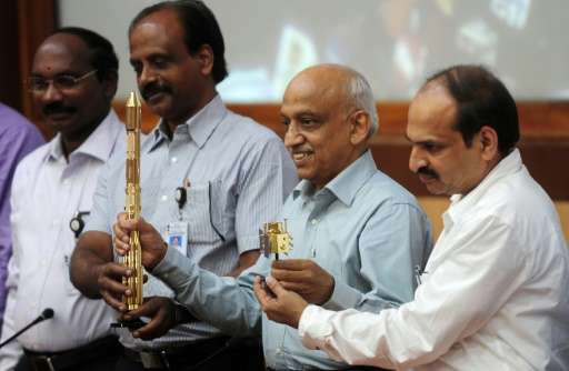 Indian Space Research Organisation Kiran Kumar Rao (2nd right) and members of his team with models of the ISRO's CARTOSAT-2 and 