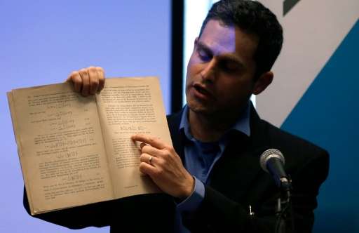 Israeli Professor Barak Kol, head of the physics department at the Hebrew University of Jerusalem, shows the original document w