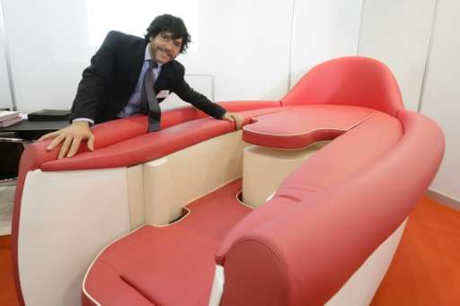 Italian inventor Mauro Cavagna shows his invention named 'Desire', a sofa designed to give greater comfort during intimate encou