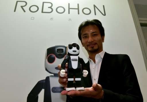 Japanese firm Sharp presented a tiny prototype robot called RoBoHon, pictured on October 6, 2015, that doubles as a mobile telep