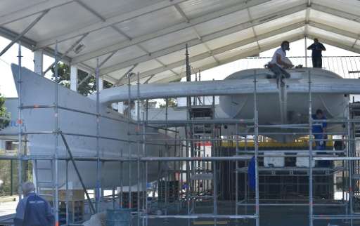 Labourers work on on the hull of an under-construction self energy producer, multihull 'Energy Observer', in Saint-Malo, western