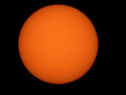 Mercury (black dot upper left) is seen passing in front of the sun through a solar telescope in Guwahati, India on May 9, 2016