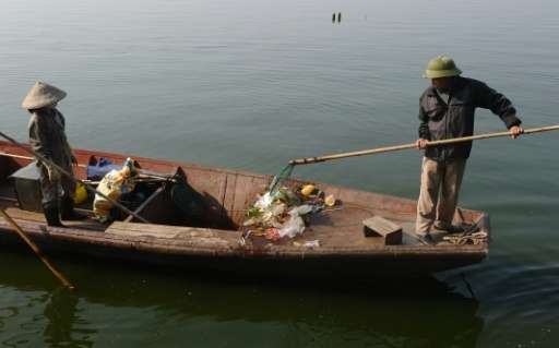 Municipal environmental workers collect waste on Hanoi's largest lake Ho Tay (West Lake)