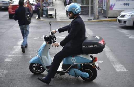 One of the electric motorcycles from the &quot;Econduce&quot; (Edrive) program takes to the roads of Mexico City, a sprawling me