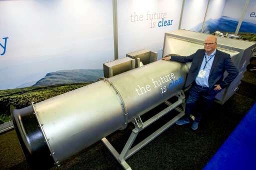 One of the group's Managing Partner Peter van Wees posing next to a system he created to filter fine and ultra-fine particles fr
