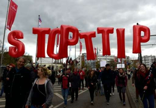 Opponents of a proposed transatlantic trade deal hold inflatebale letters reading 'Stop TTIP' during a prostest rally in Hanover
